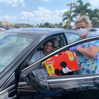 Photos by Beverly Jones: Lisa Kieffer, pre-natal outreach manager with Martin County Healthy Start Coalition meets client Kushboo Bohia in the parking lot with formula for her infant.