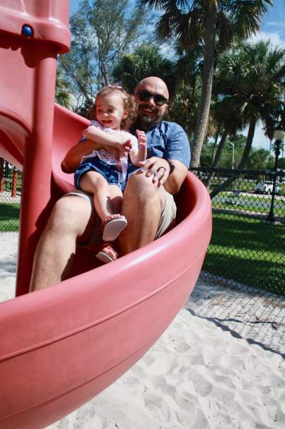 Drew Gray, fatherhood educator of the David Cardno Father & Child Resource Center in Stuart, enjoys playing with his daughter Rylie at Flagler Park. Photo by Beverly B. Jones